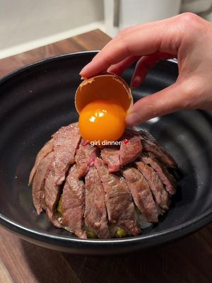 A Taiwanese wagyu beef crack bowl for girl dinner🌶️🥩 A mound of rice hiding stir-fried pickled mustard greens, topped with torched Taiwanese chili garlic butter, seared wagyu yakiniku beef, an egg yolk, and flaky salt.  Crack Butter 50 grams unsalted butter, softened 1.5 -2 tablespoons chili bean paste (doubanjiang) 2 tbsp coriander, finely chopped 1 garlic clove, grated 1/2 teaspoons salt 1. Mix butter together & set aside.  Pickled Mustard Greens 1 packet pickled mustard, chopped finely  1 garlic clove, minced 1 tbsp Shaoxing wine 1 tsp sugar salt, to taste 2. Heat 1 tbsp neutral oil in a pan. Add garlic, pickled mustard greens, & stir-fry until fragrant. Deglaze with Shaoxing wine and season with sugar & salt.  Beef 1 packet wagyu yakiniku beef slices  salt  3. Heat a little oil in a pan. Season beef slices with salt and sear on high heat until caramelised, 1-1.5 minutes. Remove & rest.  Assemble:  Cooked rice  1 raw egg yolk Flakey sea salt  4. Pack some cooked rice into a small bowl, pressing the mustard greens mixture into the centre so it’s hidden inside. Invert the small bowl into a larger serving bowl to release a neat mound of rice. 5. Generously spread the chili garlic butter over the top of the rice mound. Torch until the butter chars slightly and melts down over the rice. 6. Slice the rested beef and arrange over the charred buttery rice. Top with 1 egg yolk and finish with 1 pinch flaky sea salt, for finishing. #girldinner #DinnerIdeas #ricebowl #wagyu #fypp 
