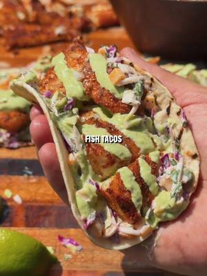 Fresh Mango Slaw Blackened Fish Tacos 🌮 The perfect dish for a hot summer day.  Recipe: -Cut the cod into pieces, drizzle with oil, and season with blackened seasoning. -Grill indirect with the vents wide open until reaching 145F internal. -Make the mango jalapeño slaw by mixing together 1 cup red cabbage, 1 cup green cabbage, 1 diced jalapeño, 1/4 cup cilantro chopped, 1 diced mango, 1/2 cup mayonnaise, 1 whole lime juiced, salt and pepper to taste. -Make green sauce by blending 1 cup greek yogurt, 1 avocado, 1 fresh jalapeño, 4 garlic cloves minced, 1/4 cup chopped cilantro, juice of 1 lime, 1/4 cup water, salt and pepper to taste. -Grill the tortillas, then assemble tacos with slaw, grilled fish, lime juice, and the green sauce. #fishtacos #grilledfish #tacotuesday #tacos #grilling