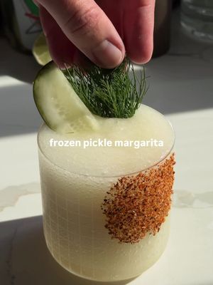 Who wants a frozen pickle margarita? 🥒 Frozen cocktails just hit different — and if you love pickle cocktails, this margarita deserves a spot in your rotation. It’s the perfect drink to cool off with on these hot days, with the pickle brine adding the perfect salty tang to elevate your classic margarita. Ingredients (per serving): — 2 oz tequila blanco  — 1 oz Cointreau — 1-2 oz pickle brine  — 3/4 oz lime juice  — 1/2 oz agave  — bar spoon of olive oil — 1 cup ice — Tajín, pickle spear and fresh dill to garnish  Combine all ingredients in a blender with ice and blend until smooth. Pour into your chilled glass with a Tajín rim. Garnish with a pickle spear and fresh dill. Enjoy! *I doubled the ingredients in the video shown* #picklemargarita #margarita #frozencocktail #easycocktail #cocktail
