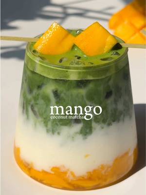 🥭🥥 mango coconut matcha This recipe takes a little patience but you’ll get a strong mango flavor without having to heat it!  No-cook mango syrup/puree — 1 cup fresh mango chunks — ½ cup sugar Mix the mango and sugar together, then refrigerate overnight to draw out the juices. Mango coconut matcha — 2 tbsp mango syrup mixture — 2 tsp (4 g) matcha — 40 ml water at 175°F — 150 ml coconut milk — Ice Instructions — Muddle the mango chunks with the syrup at the bottom of a glass — Add ice — Pour in the coconut milk — Slowly pour the matcha over the top for a layered effect — Garnish with fresh mango chunks #homecafe #matcharecipes #matchalover 
