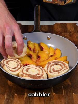 Cinnamon Roll Peach Cobbler INGREDIENTS 2 yellow peaches 1/4 c brown sugar 2 tbsp cinnamon 2 containers refrigerated cinnamon rolls 1/2 c all-purpose flour 1/3 c brown sugar 1/3 c white sugar 2 tbsp cinnamon 1/4 c melted salted butter Vanilla ice cream Remove peach pits with needle-nose pliers. Peel and slice peaches into wedges. Toss with 1/4 c brown sugar and 2 tbsp cinnamon. Let sit 5 min, then mix again to release the juices. Place peaches in a round frying or cake pan. Top with cinnamon rolls, filling any gaps (cut one into pieces if needed). Bake at 375°F for 30 min. For streusel, mix flour, 1/3 c brown sugar, white sugar, 2 tbsp cinnamon and butter. Press into clumps on a sheet tray and bake at 375°F for 20 min. Cool to harden. Let cobbler cool, flip onto a plate, and top with streusel and vanilla ice cream.  