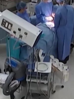Surgeons cling to a patient on the operating table mid-surgery as a powerful 7.1 magnitude earthquake violently shakes a Japanese hospital. Surveillance video shows equipment rattling and staff scrambling to keep items from falling while the surgical team works to protect the patient as the room moves around them. The earthquake struck southwestern Japan, killing at least 39 people and forcing thousands into evacuation centers.