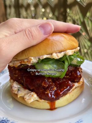 Crispy sesame Gochujang buffalo burger with kimchi mayo and quick pickled cucs 🥒 Had to revisit this one and I'm REALLY glad I did. The bun is nice, the fried stuff is nice, the pickles are niiice, the sauces (yes there are two), are NICE. And when you add all those things together you get a really really delicious thing that you won't be able to stop thinking about. I beg you to treat yourself this weekend. You'll have a great time, I promise x Pickled cucumber: ¼ cucumber, thinly sliced 30ml rice wine vinegar 1 tsp caster sugar Gochujang buffalo sauce: 50g gochujang 65g vegan butter, softened or melted 1 tbsp soy sauce 1 tosp rice wine vinegar 25g agave ½ tsp ginger, grated 1 clove garlic 4 large oyster mushrooms or 1 block tofu, cut into slabs Dredge: 60ml oat milk + 30g plain flour 30g plain flour + 1 tsp garlic powder 50g panko breadcrumbs + 25g sesame seeds Salt 400-500ml veg oil Burger buns Spring onions 1. Salt the cucumber slices in a bowl and set to one side for about 10-15 minutes then rinse, drain and squeeze out excess moisture. Add the sugar and vinegar and allow to pickle whilst you prepare the other ingredients. 2. Whisk together all the ingredients for the Gochujang buffalo sauce. Add to a small saucepan and simmer for a minute or two until it thickens and gently caramelises. 3. Prepare the dredge for mushrooms/tofu. Whisk the oat milk and flour together until a thin paste forms. In another bowl mix plain flour with garlic powder with a pinch of salt. In a final bowl mix the panko, sesame seeds and another pinch of salt. 4. Dip the mushrooms or tofu first into the flour and garlic mixture, then in the wet batter then in the panko breadcrumbs. Set to one side. 5. Squeeze excess moisture from the chopped kimchi then combine with the mayo with a drop of the juice to thin it out a little. 6. Heat the oil in a large frying or saucepan (ensuring not to fill it over half way). Once hot, add the mushrooms/tofu and fry for around 5-7 minutes until golden brown on both sides and cooked through. 7. Toast the buns then load with kimchi mayo, fried mushrooms/tofu, pickles and spring onions. Enjoy! #veganburger #friedmushrooms 
