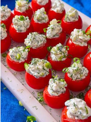 Cherry tomatoes filled with cream cheese, feta, and dill for a Greek flair — only 1 Point per serving 🍅 Ingredients: 24 medium cherry tomatoes, stems removed ¼ cup reduced fat whipped cream cheese 3 tbsp crumbled feta cheese 1 tbsp reduced calorie mayonnaise ⅛ tsp black pepper, freshly ground ¼ cup English cucumber, finely diced 2 tbsp scallions, finely chopped (plus extra for garnish) 2 tsp dill, chopped (plus extra for garnish) Instructions: 1. Carve out a shallow cavity in bottoms of tomatoes; gently squeeze out some of the seeds. 2. In a small bowl, combine cream cheese, feta, mayo and pepper; gently stir in cucumber, scallion and dill. Spoon cheese mixture into a quart-size zip-close plastic bag; snip off one corner of bag and pipe mixture evenly into tomatoes. 3. Arrange tomatoes on a serving platter; garnish with chopped scallions or dill. Refrigerate at least 30 minutes or until slightly chilled. Serving size = 2 stuffed tomatoes