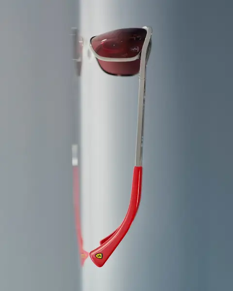 This iconic design pays tribute to Scuderia Ferrari HP’s home race and legendary driver Michael Schumacher, blending timeless racing heritage with '90s fashion. Featuring the team’s signature red, the slim metal frame, dynamic wraparound lenses, and pilot-inspired double bridge deliver both style and precision. Finished with red-grey gradient lenses, this design celebrates legacy and speed with a bold edge.
