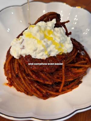 Spaghetti all’Assassina is a smoky Bari specialty where dry spaghetti cooks directly in rich tomato broth until tender underneath and deeply scorched and caramelized on the edges, then gets finished with creamy stracciatella, basil, and olive oil.