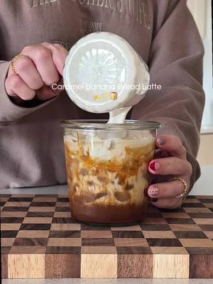 Caramel Banana Bread Latte 🍌🤎🫶🏼 FULL recipe below!  Recipe:  Rim glass with caramel sauce @Trader Joe's (optional)  Brew 2 shots espresso over 1 tsp caramel sauce & 1 tbsp banana bread syrup (using homemade)  Add ice & milk to fill glass  Banana bread cold foam:  2 tbsp heavy cream  1 tbsp banana bread syrup  Froth until thick  Banana bread syrup:  2 ripe bananas  Cinnamon, flakey salt @Maldon Salt  1 cup brown sugar  1 cup water  Simmer for 8-10 min.  Add 1 tsp vanilla extract  Blend or strain #coffee #coffeetiktok #coffeeathome #coffeerecipe #bananabread 