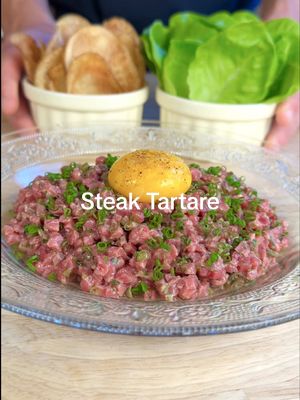 How to Make Steak Tartare 🥩 - THE TARTARE SERIES ep. 1  FULL RECIPE BELOW ⬇️  INGREDIENTS: - 250g beef (SEE NOTES BELOW ON CHOOSING THE RIGHT CUT) - 1/2 small shallot - 1 tbsp chopped gherkin pickles - 1 tbsp chopped capers - 1 tbsp chopped parsley - 1/4 bunch chives  - 1 tsp Dijon mustard - 1 tbsp lemon - 2 tbsp olive oil - tobasco, Worcestershire to taste - salt and fresh cracked pepper to taste - 1 large russet potato  - 1L canola oil (for frying) - 1 head gem lettuce - 1 egg yolk NOTES ON CHOOSING THE RIGHT CUT: - I recommend going to your local butcher, and asking which cut they recommend for tartare. A reputable butcher is one that receives whole animals, or primal cuts that they break down themselves.  - DO NOT use pre-ground beef for tartare. Ground beef has much more surface area that can be exposed to bacteria, and can also get contaminated through the grinding process. Make sure you buy a whole cut of beef, and cut/grind it yourself.  - Buy your beef the same day you intend to make tartare, and make sure your beef stays cold! I recommend bringing a cooler bag with ice packs to the butcher.  - If there is harmful bacteria on a cut of beef (although the risk is very low if you follow the above steps), it will live on the outside of the cut. If you want to be EXTRA safe when eating tartare, you can quickly sear the outside of your steak in a hot pan, and cut off the seared portion. I personally don’t do this, but this could give some people some extra piece of mind.  - You are looking for a cut that is lean, with no excess fat or marbling. Tenderloin will be more tender, and on the more expensive side. Cuts like the top round, inside round etc, will be more chewy, but also less expensive. I used top round for the tartare in this video.  INSTRUCTIONS: TARTARE: 🥩 1) Thinly slice your beef approx. 3 mm thick, and lay the strips on a sheet pan lined with parchment paper. Place the tray in the freezer until beef is semi-frozen. 2) While waiting for your beef to freeze, finely chop your shallot, gherkins, capers, and parsley. Finely chop your chives and set aside. 3) When your beef is semi-frozen, dice it into approx. 3mm dice. While you are dicing, keep your beef on the frozen tray, as it will keep it cold.  4) In a large chilled bowl, mix your Dijon, lemon juice, and olive oil, along with a few dashes of tobasco and Worcestershire. Keep whisking until the dressing has emulsified. Add your beef to the bowl, along with your shallots, parsley, gherkins and capers. Season with salt and freshly cracked pepper. Taste your tartare and adjust seasoning.  5) Plate your tartare on a chilled plate, garnish with chives and your egg yolk. Serve with potato chips and lettuce leaves. POTATO CHIPS 🥔 1) Preheat a pot of canola oil to 300 degrees Fahrenheit. 2) Thinly slice your potatoes lengthwise on a mandolin approx 1mm thick, being sure to keep the thickness as constant as possible. Soak your chips in cold water, changing the water 3-4 times until clear.  3) Remove your chips from the water, and pat them dry with paper towel.  4) Working in small batches, fry your potato chips, stirring often, ensuring your chips stay submerged as best as possible (you might have to press them down with a slotted spoon or strainer). 5) When your chips are just slightly golden (do not wait until they are brown - as they will taste bitter), remove them from the oil, and season them with fine sea salt. Place them on a tray lined with paper towel for oil to drain easily off chips. #steak #tartare #beef #Recipe #homecooking