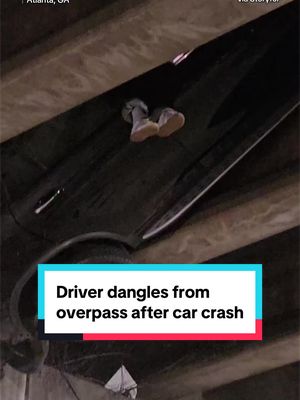 A person was seen dangling from an overpass in downtown Atlanta after a car crashed through part of the roof of a tunnel on Sunday. Video captured by a witness shows the person’s feet hanging above the roadway as the vehicle remained stuck overhead. The witness said traffic had come to a standstill when he noticed people pointing toward the tunnel roof. Local reports said authorities helped the person out of the vehicle and that they escaped without major injuries.