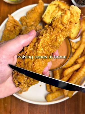 Raising Cane’s at Home 🐔🏠 For all of you asking - the app link for Osta is in my bio or you can search “Osta Recipes” on the App Store or Google Play store ‼️🫶 Crispy buttermilk chicken tenders, addictive Cane’s sauce and fluffy texas toast… all at home! For the Chicken: -2 lbs (0.9 kg) chicken breast, sliced into strips (or use tenderloins) -2 cups buttermilk -1/3 cup pickle juice -Seasonings: 1 tsp garlic powder, 1 tsp paprika, 1 tsp onion powder, 1 tsp salt, 1 tsp black pepper -Neutral oil, for frying Flour Mixture: -2 cups all-purpose flour +1/2 cup cornstarch -1 tsp baking powder -Seasonings: 2 tsp garlic powder, 2 tsp paprika, 2 tsp salt, 2 tsp black pepper Cane’s Sauce -1/2 cup mayonnaise -1/4 cup ketchup -2 tsp Worcestershire sauce -Seasonings: 1 tsp garlic powder, 1 tsp onion powder, 1 tsp paprika, 1 tsp black pepper, 1 tsp seasoning salt Instructions: 1. Slice the chicken breasts into strips about 1 inch thick and 3–4 inches long (roughly tender-sized). In a bowl, whisk together the buttermilk, pickle juice, and chicken seasonings until fully combined. Add the chicken and toss to coat. Cover and refrigerate for at least 2 hours, or overnight for extra tender chicken. 2. In a large bowl, combine the flour, cornstarch, baking powder, and flour mixture seasonings. Mix. 3. Add neutral oil to a large pot or deep skillet until it is about 2–3 inches deep. Heat the oil to 350°F / 175°C. Keeping the oil around this temperature ensures crispy chicken without burning the coating. 4. Drizzle a little buttermilk marinade into the flour mixture and stir to create flaky, crispy bits. Shake excess marinade off the chicken, then coat each piece thoroughly in the flour mixture. Shake off any extra flour and gently place into the hot oil. 5. Don’t touch them for the first 1–2 mins, that’s how you get the perfect crust. Fry for 7–10 mins, or until golden brown and cooked through. Transfer the chicken to a paper towel-lined rack to drain. 6. In a bowl, combine all the sauce ingredients then refrigerate. 7. Serve the chicken with a side of sauce, texas toast and fries! Enjoy :) #raisingcanes #cookingathometiktoktv #Recipe #cooking #recipesoftiktok 