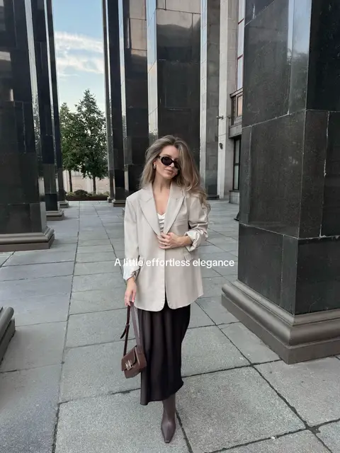 Elegant autumn outfit featuring a taupe blazer, chocolate brown satin midi skirt, brown heeled boots, and a rich burgundy-brown handbag. A sophisticated mix of warm neutrals and deep autumn tones, perfect for a timeless, feminine, quiet luxury aesthetic.