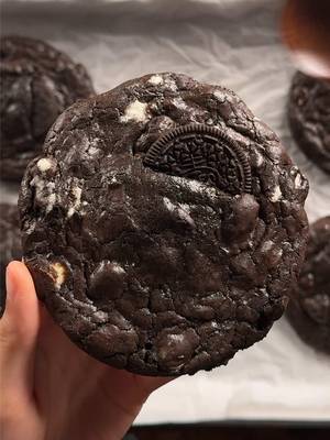 cookies n cream brownie cookies 2 cups (340g) bittersweet or semisweet chocolate 3/4 cup (170g) unsalted butter 1/2 cup (100g) white sugar 1 1/3 cups (270g) brown sugar 4 eggs 2 tsp (8g) vanilla extract 1 1/2 cups (190g) ap flour 1/2 cup (50g) dutch process cocoa powder 3/4 tsp (4g) salt 3/4 cup (100-120g) oreo cookies 1 cup (150-180g) white chocolate chips +extra oreos for assembly. *in a microwave safe bowl, gradually microwave the butter and chocolate together until its smooth. do it in 15-20 sec increments to not burn the chocolate. whisk in the cocoa powder while its still warm and then set this aside. in a large bowl, whisk together the eggs and sugars together well until its foamy. then add in the cooled chocolate/butter mixture and mix until combined. then add in the vanilla. gently mix in the dry ingredients. then fold in the chopped oreos and white chocolate. set in the fridge for an hour. scoop and place a oreo on the bottom, then bake at 350 for 11-14 min or until the top looks set and crackly a bit! #cookiesandcream #brownie #cookies 