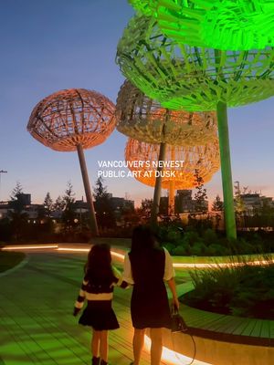 Vancouver’s newest public art comes alive at dusk. ✨ Last night, we watched Bush Capsules by acclaimed Canadian artist Brian Jungen illuminate for the first time at The Commons at @oakridgepark. The changing lights completely transform the installation after dark — such a beautiful addition to Vancouver’s public art scene.  📍 The Commons at Oakridge Park 650 W 41st Ave, Vancouver #OakridgePark #PublicArt #CulturalHub #VancouverEvents #vancouverbc 