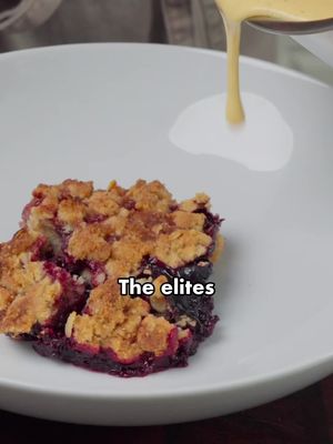 Blackberry crumble with caramelised edges, and proper custard to drown it in. CRUMBLE, serves 6 Filling: 700g blackberries, 75g caster sugar, 2 tbsp cornflour, zest and juice of 1 lemon. Toss together and leave 15 mins. Topping: rub 125g cold cubed butter into 150g plain flour and 50g ground almonds, stopping at coarse crumbs with a few pea-sized lumps of butter still visible. Stir in 50g jumbo oats, 75g demerara, 50g light brown sugar, half a tsp flaky salt. Squeeze into fistfuls, then break them apart so you get nuggets from pea to hazelnut size. Freeze 20 mins. Oven to 200C, 180C fan, with a heavy tray inside. Fruit into a wide dish, no deeper than 4cm. Scatter the crumble loosely right to the edges. 25g demerara over the top. Bake 30 mins on the hot tray until deep gold and bubbling thickly at the rim. Rest 15 mins. CUSTARD 500ml, half whole milk and half double cream, with 1 split vanilla pod. Heat to steaming, then infuse 20 mins with the lid on. Whisk 6 yolks with 75g caster sugar, 1 tsp cornflour (optional) and a pinch of salt. Reheat the cream, pour a third into the yolks while whisking to temper it, then return it all to the pan. Stir constantly over low heat to 82C, until it coats a spoon and a finger drawn through leaves a clean channel. Strain straight into a cold jug. The cornflour is your safety net. Some people like to take it up to 95°C with cornflour to reduce the risk of it being chalky. I’ve never found that necessary as it’s only 1 tsp anyway. So you can go to 82/83°C quite happily. Make the custard while the crumble rests, so both arrive warm.