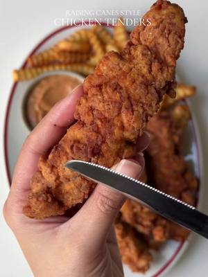 Raising Cane’s Style Chicken tenders Ingredients: For the Chicken: 2 lb chicken breast, cut into strips Oil for frying For the Dry Batter: 2 cups all purpose flour 1/3 cups cornstarch 1 tsp baking powder  1 tbsp smoked paprika Salt to taste 1 tbsp garlic powder 1 tbsp onion powder  1 tsp black pepper For the Wet Batter: 2 cups buttermilk 1 tbsp garlic powder 1 tbsp onion powder  1 tsp black pepper Salt to taste 1 tbsp smoked paprika 1/3 cup hot sauce  1/4 cup pickle juice  For the Cane’s Sauce: 4 tbsp ketchup 2 tbsp Worcestershire sauce 1 1/2 tsp garlic powder 1 tsp black pepper 1 cup mayonnaise Salt to taste 1 tsp smoked paprika Instructions: Prepare the wet batter by whisking together buttermilk, hot sauce, pickle juice, garlic powder, onion powder, black pepper, salt, and smoked paprika. Add the chicken strips to the wet batter and marinate for at least 2 hours or overnight. Prepare the dry batter by whisking together flour, cornstarch, salt, garlic powder, onion powder, black pepper, and smoked paprika. Remove the chicken from the wet batter, allowing excess to drip off, then coat each strip in the dry batter.  Dip the chicken back into the buttermilk mixture, then coat it a second time in the dry batter, pressing and squeezing the flour mixture onto the chicken to create a craggy, crunchy coating. Place the coated chicken on a wire rack and let it rest for 5–10 minutes before frying. Repeat with the remaining chicken. Deep fry the coated chicken strips in hot oil (about 350°F) until golden brown and cooked through, approximately 8-10 minutes, flipping halfway through. Prepare the Cane’s Sauce by whisking together mayonnaise,ketchup,Worcestershire sauce, garlic powder, black pepper, salt, and smoked paprika. Serve the crispy chicken tenders with Cane’s Sauce. #Recipe #chickentenders 
