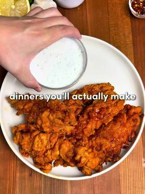 Hot Honey Chicken Tenders 🍯🔥  For all of you asking about the app I made (it’s free!!) you can search “osta” on the App Store or Google Play 😁 A little sweet, a little spicy and majorly crispy… served with buttermilk ranch.  For the Chicken: -2 lbs (0.9 kg) chicken breast, sliced into strips -2 cups buttermilk -1/3 cup pickle juice -Seasonings: 1 tsp garlic powder, 1 tsp paprika, 1 tsp cayenne pepper, 1 tsp onion powder, 1 tsp salt, 1 tsp black pepper -Neutral oil, for frying Flour Mixture: -2 cups all-purpose flour +1/2 cup cornstarch -1 tsp baking powder -Seasonings: 2 tsp garlic powder, 2 tsp paprika, 2 tsp salt, 2 tsp black pepper Hot Honey Sauce: -1/4 cup butter -2 to 3 tbsps hot sauce -1/3 cup honey For the Ranch:  -1/2 cup mayonnaise + 1/2 cup sour cream -1/2 cup cold buttermilk (use less for a thicker dip) -1 teaspoon red wine vinegar  -1 teaspoon dried parsley -1 tbsp fresh dill weed (or 1 tsp dried dill) -Spices: 1/2 tsp garlic powder, 1/2 tsp onion powder, 1/2 tsp fine sea salt, 1/2 tsp black pepper -1 tbsp fresh chives, optional Instructions: 1. Slice the chicken breasts into strips about 1 inch thick. Add to a mixing bowl with buttmilk, pickle juice, & chicken seasonings. Mix together. Cover & refrigerate for at least 2 hours, or overnight for extra tender chicken. 2. In a bowl, combine the flour, cornstarch, baking powder, and flour mixture seasonings. Mix. 3. Add neutral oil to a large pot until it is about 2–3 inches deep. Heat the oil to 350°F / 175°C. Keep the oil around this temp at all times.  4. Drizzle a little buttermilk marinade into the flour mixture & stir to create flaky bits. Shake excess marinade off the chicken, coat each piece in the flour mixture. Shake off extra flour & place into the oil. 5. Don’t touch them for the first 1–2 mins. Fry for 7–8 mins, or until golden brown and cooked through. Transfer to wire rack.  6. Meanwhile, melt butter over medium-low heat. Add honey and 2–3 tbsp hot sauce and whisk until smooth.  7. Mix the ranch ingredients in a bowl.  8. Toss or brush the tenders with the hot honey sauce. Serve with buttermilk ranch & enjoy! #cookingathometiktoktv #Recipe #recipesoftiktok #easydinner 