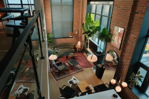the apartment at golden & blue hour • • #interiordesign #apartmentdecor #homedecor #homeinspo #homebody • • mid-century modern | toronto interior | brick loft living | warm light | lived-in spaces | hard loft | tall ceilings | large windows | natural light | vintage furniture | statement lighting | plants | architectural details | open living | modern apartment | home atmosphere | interior styling | design focused | quiet spaces