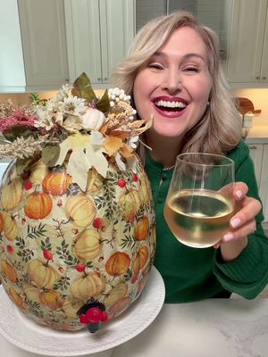 Pumpkin Wine Dispenser  Easy to create  •use a craft pumpkin  •cut a hole and the top and a small hole for the wine spout near the base (I used a the top of a pill bottle to trace) •decoupage using mod pog and a pretty napkin (cut out pieces of napkins and piece them together. It doesn’t have to be perfect) •hot glue artificial flowers and leaves to the lid  •take the bag out of a box of wine and place inside  •push the spout through  •place an ice pack inside