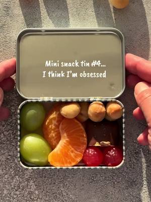 Why is a tiny snack tin SO much more exciting than a normal snack? 😂👀 Today’s little lineup: 🍊 2 mandarin segments 🍇 2 green grapes 🌰 @Australian Macadamias  🍫 chocolate 🍬 gummies Tell me your 5 things for the ultimate mini snack tin 👇 . . #snack #snacktin #snacking #tiktokfood #minisnacks 