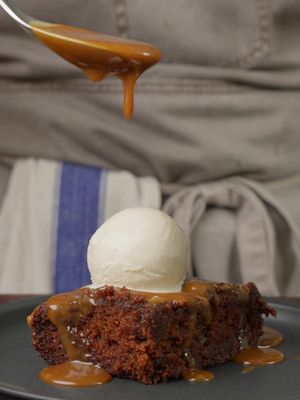 DARJEELING STICKY TOFFEE PUDDING 9x9” square tin   TIN 10g butter, 1 tbsp demerara sugar (optional)   DATES 2 Darjeeling tea bags, 300ml boiled water, 200g pitted Medjool dates (chopped), 1 tsp bicarbonate of soda   SPONGE 85g unsalted butter (soft), 115g dark muscovado sugar, 2 large eggs, 1 tbsp golden syrup, 1 tbsp black treacle, 1 tsp vanilla, 175g self-raising flour, 75ml milk   SAUCE 300ml double cream, 1 Darjeeling tea bag (optional), 115g unsalted butter, 150g light muscovado sugar, 2 tbsp golden syrup, 1 tbsp black treacle, ¼ tsp sea salt   METHOD 1. Heat oven to 180°C (160°C fan). Butter the tin, add the demerara, shake to coat and tap out the excess. 2. Steep the tea bags in the water for 4 mins, squeeze and remove. Simmer the dates in the tea for 5 mins until very soft. Off the heat, stir in the bicarb (it will foam), blend fairly smooth and cool slightly. 3. Beat the butter and dark muscovado for 3 mins until fluffy. Beat in the eggs one at a time, then the golden syrup, treacle and vanilla. 4. Fold in the flour, then the milk, then the date puree. It will look far too runny; that's exactly right. 5. Bake for 25 to 30 mins, until a skewer comes out clean. 6. For the sauce, warm the cream until steaming, steep the tea bag for 5 mins, squeeze and remove. Melt the butter and light muscovado, add the golden syrup and treacle and bubble for 2 to 3 mins until glossy. Add the cream in two batches, then simmer gently for 5 mins until slightly thickened. Stir in the salt. 7. Poke holes all over the hot sponge. Pour over a third of the sauce, leave for 5 mins, then bake for 5 more mins until bubbling at the edges. 8. Rest for 10 mins, slice and serve with more sauce and vanilla ice cream. I won't hear of any alternative.   #stickytoffeepudding #britishbaking #puddingrecipe #stp