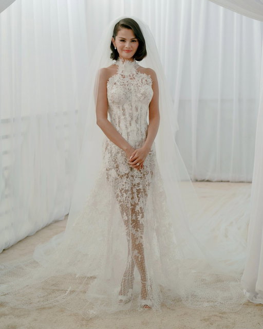 Ralph Lauren created a custom #RLCollection wedding gown for #SelenaGomez that featured a hand-painted corset with more than 300 hand-shaped lace flowers in a cascading train, inscribed with the couple’s initials and wedding date. 