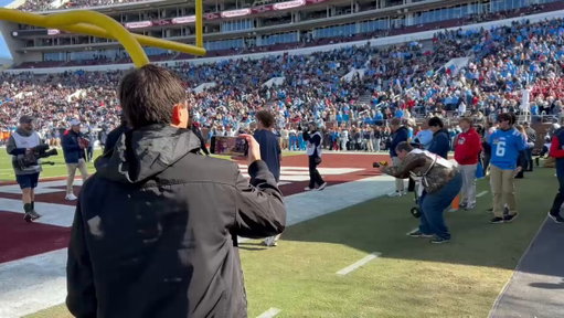 Lane Kiffin and Ole Miss chancellor Glenn Boyce embrace as Kiffin leaves the field after pregame warmups. 