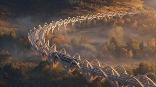 Proposals for a high-speed rail loop that would link nine urban centres across Great Britain and Ireland have been put forward by RIBA President Chris Williamson. The so-called ‘Northern Loop’ would create a ‘dispersed but connected’ global city of around ten million people.

Williamson suggests that the Northern Loop would cost £130BN to construct and deliver £12BN a year in economic benefits. He confirmed in a social media post on 8 February that the proposal had been submitted to the Royal Academy’s 2026 summer exhibition.

“Maybe I have been too influenced by the scale, the vision and the ambition of The LINE in Saudi Arabia, having worked on the high-speed stations running alongside the 170-kilometre city for the last few years,” said Williamson in a statement provided to The B1M. “But we in the British Isles should be equally ambitious about our future. At present the Government seems to expect each city to compete for the same investment funding, when we need to encourage connectivity and collaboration.”

Locally-sourced stone arches would be used to the elevate the tracks above the landscape – minimising disruption and creating the flat, straight runs that are key to any high-speed line. Engineering consultants Elliott Wood have provided input into the proposals from an early stage.

“Britain needs a vision that can excite the country, regenerate the economy and restore confidence,” said Williamson. “Architects once published manifestos. They were not always right, but they inspired, provoked and set out ideas they believed in. This project is intended as a return to that time.”

More here 👉 https://t.co/HVMggt4hm1

📷 Chris Williamson