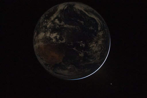 Even in darkness, we glow. 
 
In this image of Earth taken by the Artemis II crew, we can see the electric lights of human activity. In the lower right, sunlight illuminates the limb of the planet. 