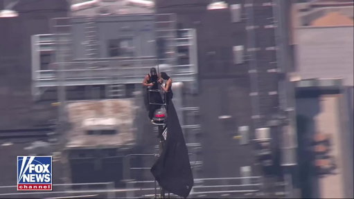 BREAKING: Two people have climbed to the top of the Empire State Building in New York City, holding a banner from the skyscraper's antenna reading, "When the power of love beats the love of power, the world knows peace."

As of now it's unclear how the pair reached the top of the building as police work to get them down from the spire, 1,454 feet above the ground.
