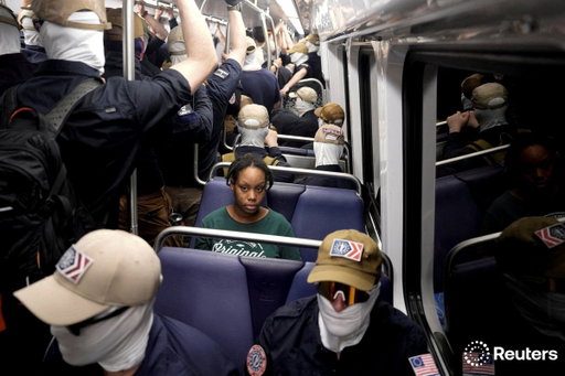 This image is from today. A Black woman sits on the DC metro as masked white nationalists prepare to march on our nation's capital. 

This is America's 250th anniversary.  REUTERS/Cheney Orr 