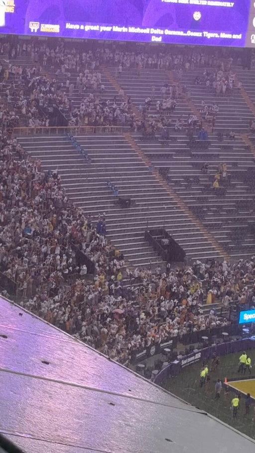 #LSU turns on the purple lights snd plays #PurpleRain as the torrential downpour comes in.

Student section remains packed. They came to play today. 