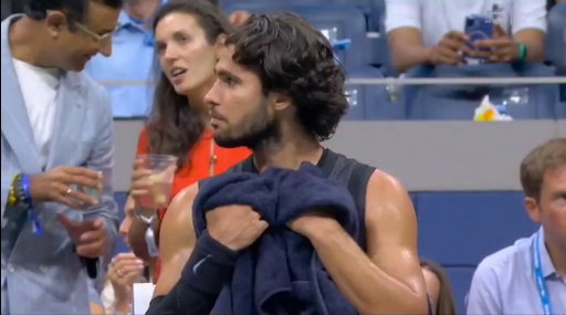 Carlos Alcaraz seen vomiting into a towel during his clash with Ben Shelton.

