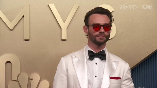 Thomas Doherty poses on the Emmys carpet 