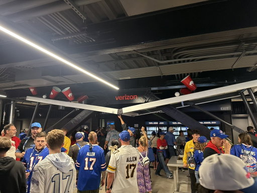THE BILLS NEW STADIUM HAS A DRINK COOLER UNDERNEATH A BROKEN FOLDING TABLE 
