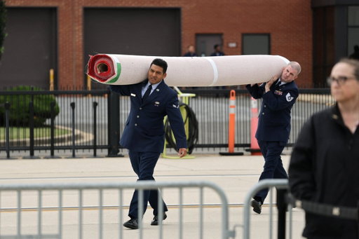 A red carpet is carried ahead of the arrival of Chinese President Xi Jinping at Joint Base Andrews, Maryland, US, September 23, 2026. REUTERS/Jonathan Ernst 