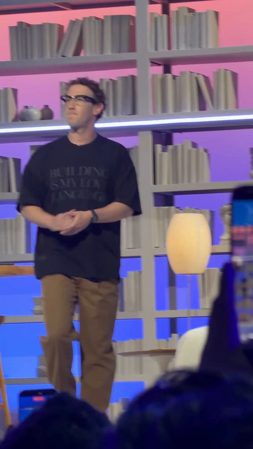 Zuck taking the stage in a “building is my love language” shirt

One of us 