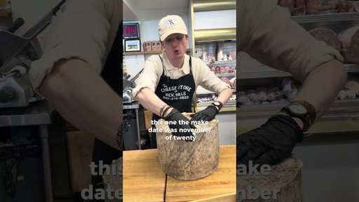 Cutting a 60 pound wheel of cheddar cheese #cheesemonger #cheese
