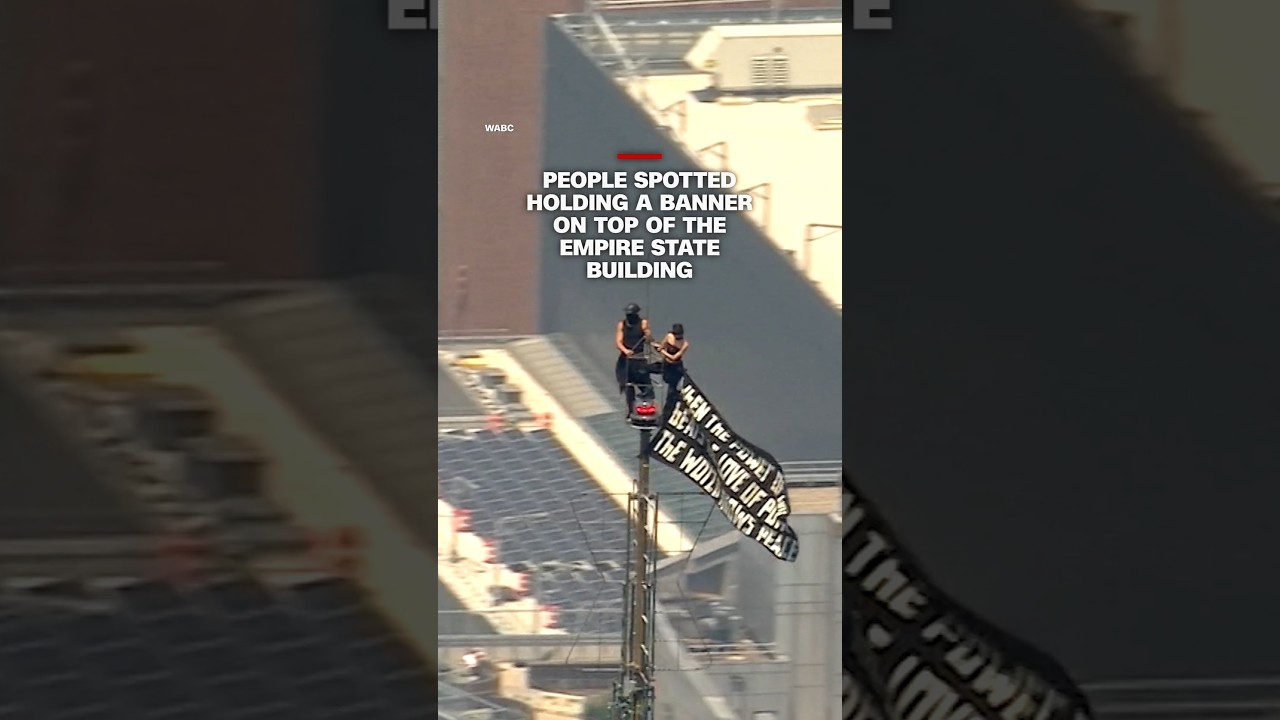 People spotted holding a banner on top of the Empire State building