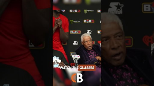 Dr. J shows off his purple velvet outfit & matching shades