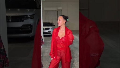 Kim Kardashian wears the SKIMS Romance Button Up Shirt and Pant Set.